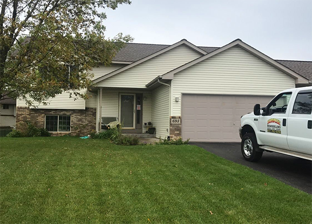 Before and after photo of a home's exterior with new siding installed by Sunrise Remodelers.